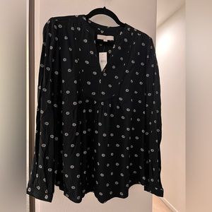 Black long- sleeved top.